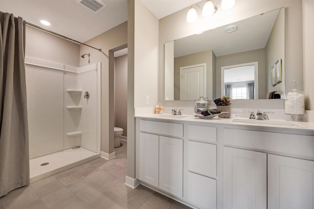 17021 Draper Way, Lakeville, MN 55044 - full bathroom featuring double vanity, a shower, and tile patterned floors