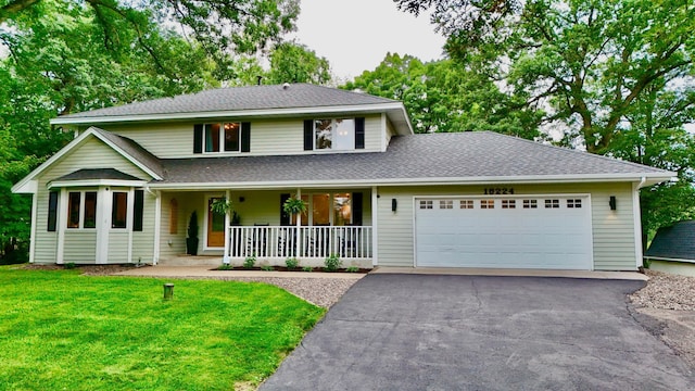 18224 Flanders St NE, East Bethel, MN 55092 - view of front of house with covered porch, an attached garage, driveway, a front lawn, and a shingled roof