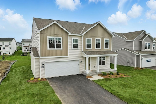 19391 Clearwater Loop, Farmington, MN 55024 - view of front of property with board and batten siding, an attached garage, asphalt driveway, and roof with shingles