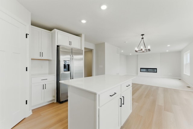 19391 Clearwater Loop, Farmington, MN 55024 - kitchen with stainless steel fridge with ice dispenser, light wood-type flooring, a kitchen island, recessed lighting, and white cabinetry