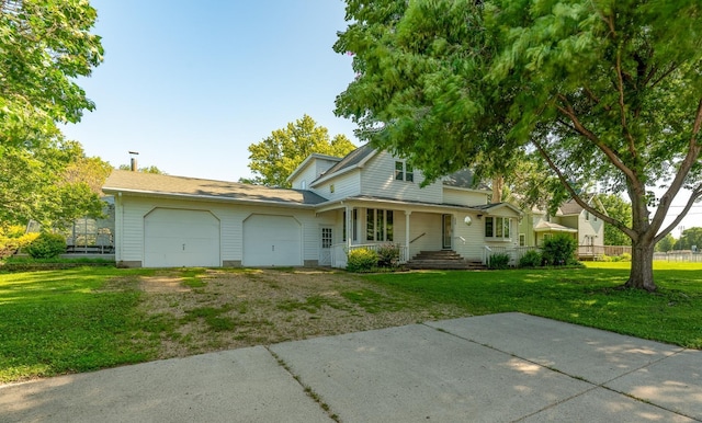 208 Lincoln St SW, Mapleton, MN 56065 - view of front of property with an attached garage, driveway, a front lawn, and covered porch