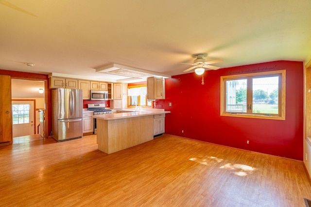 208 Lincoln St SW, Mapleton, MN 56065 - kitchen featuring appliances with stainless steel finishes, light wood-style floors, a peninsula, light countertops, and a ceiling fan