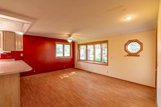 208 Lincoln St SW, Mapleton, MN 56065 - unfurnished living room featuring light wood-type flooring and a ceiling fan