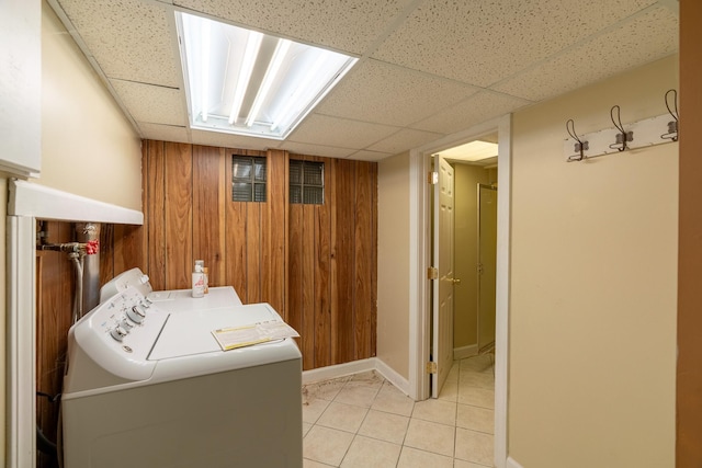 208 Lincoln St SW, Mapleton, MN 56065 - laundry area with washer and clothes dryer, light tile patterned floors, and wood walls