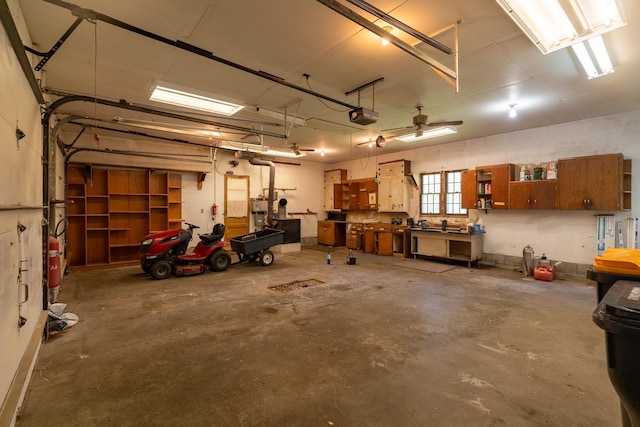 208 Lincoln St SW, Mapleton, MN 56065 - garage with a garage door opener and a workshop area
