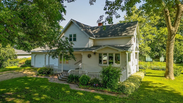 208 Lincoln St SW, Mapleton, MN 56065 - view of front of property with a front lawn, a chimney, and a porch