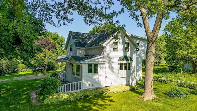 208 Lincoln St SW, Mapleton, MN 56065 - view of home's exterior with a chimney, a yard, and roof with shingles