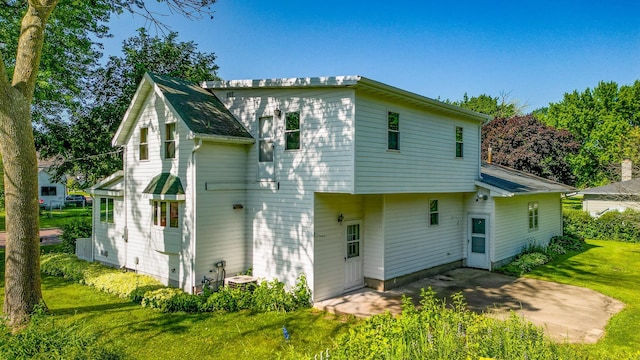 208 Lincoln St SW, Mapleton, MN 56065 - rear view of property featuring a yard and a patio area