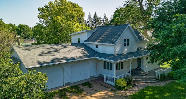 208 Lincoln St SW, Mapleton, MN 56065 - back of house with covered porch, a shingled roof, and an attached garage