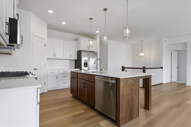 14990 144th Ave N, Dayton, MN 55327 - kitchen with appliances with stainless steel finishes, light wood finished floors, decorative backsplash, light countertops, and recessed lighting