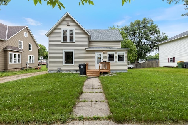 205 Main St, Marshall, MN 56258 - back of property featuring a shingled roof and a wooden deck