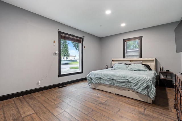 205 Main St, Marshall, MN 56258 - bedroom with hardwood / wood-style flooring, multiple windows, and recessed lighting