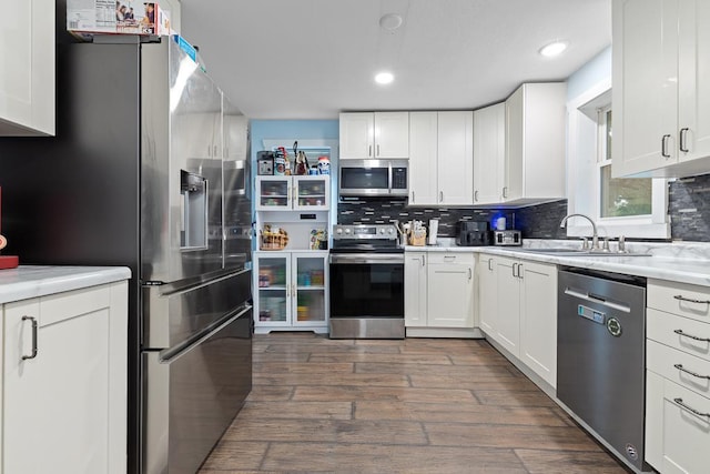 205 Main St, Marshall, MN 56258 - kitchen featuring appliances with stainless steel finishes, white cabinetry, backsplash, light countertops, and recessed lighting