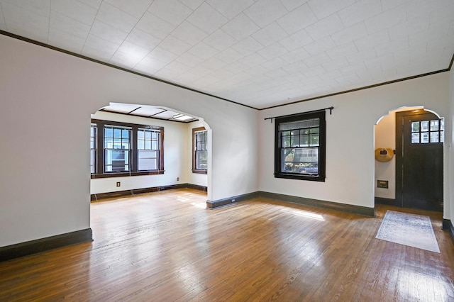 4623 Blaisdell Ave S, Minneapolis, MN 55419 - spare room featuring arched walkways, healthy amount of natural light, hardwood / wood-style floors, and crown molding