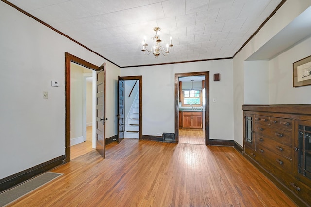 4623 Blaisdell Ave S, Minneapolis, MN 55419 - unfurnished room featuring ornamental molding, a chandelier, wood-type flooring, and stairs