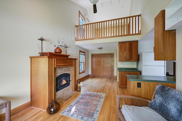 4623 Blaisdell Ave S, Minneapolis, MN 55419 - living room with a high ceiling, light wood-type flooring, a fireplace, and ceiling fan