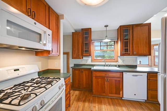 4623 Blaisdell Ave S, Minneapolis, MN 55419 - kitchen featuring white appliances, brown cabinetry, light wood-type flooring, dark countertops, and glass insert cabinets