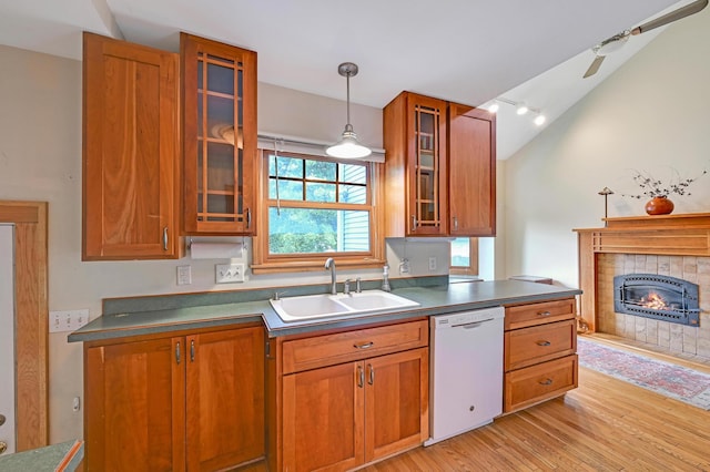 4623 Blaisdell Ave S, Minneapolis, MN 55419 - kitchen with white dishwasher, light wood-style flooring, brown cabinets, a fireplace, and lofted ceiling