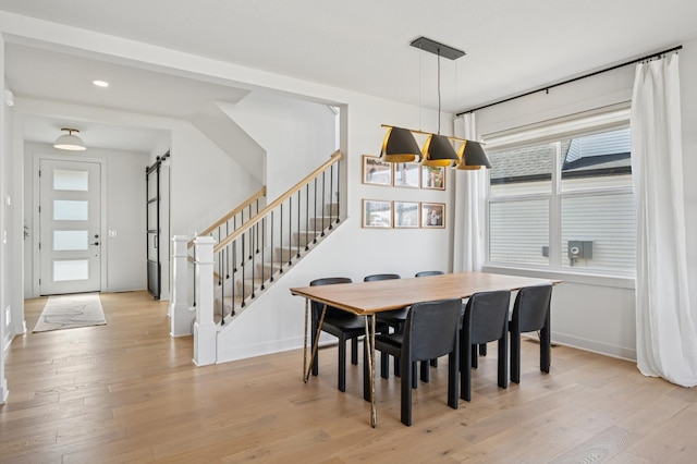 2348 Kester Ave NE, Saint Michael, MN 55376 - dining space with stairway, a barn door, plenty of natural light, light wood finished floors, and recessed lighting