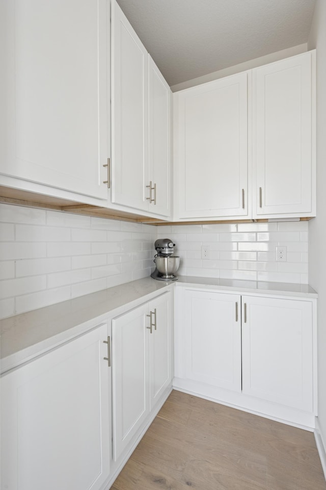 2348 Kester Ave NE, Saint Michael, MN 55376 - kitchen featuring light countertops, decorative backsplash, white cabinets, and light wood-style flooring
