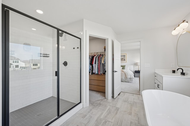 2348 Kester Ave NE, Saint Michael, MN 55376 - full bathroom with a freestanding tub, vanity, a shower stall, connected bathroom, and recessed lighting