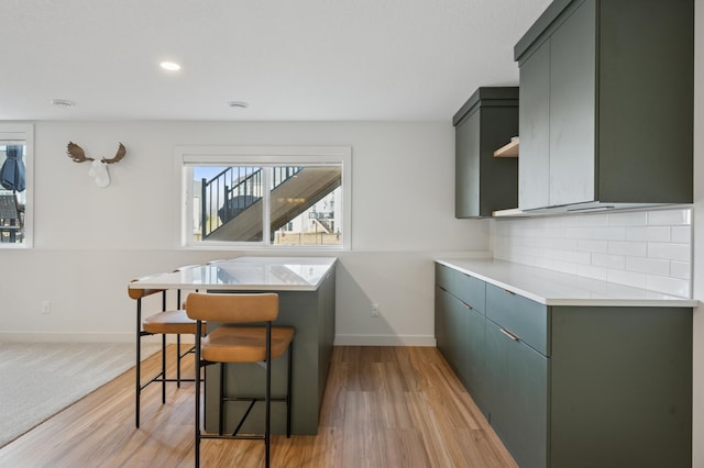 2348 Kester Ave NE, Saint Michael, MN 55376 - kitchen featuring light wood finished floors, decorative backsplash, light countertops, recessed lighting, and green cabinetry