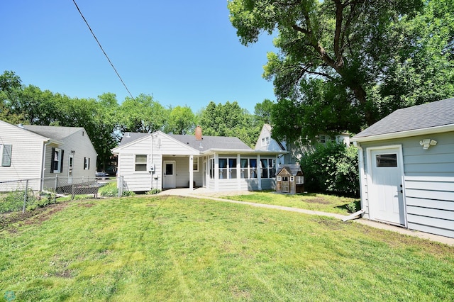 1253 3rd St N, Fargo, ND 58102 - back of property with a sunroom and a storage unit