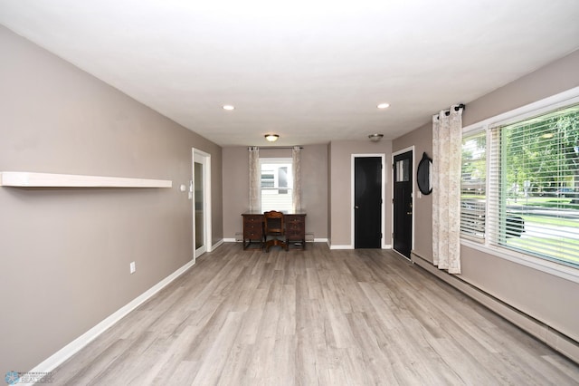 1253 3rd St N, Fargo, ND 58102 - living area featuring a baseboard heating unit, light wood-style flooring, and recessed lighting