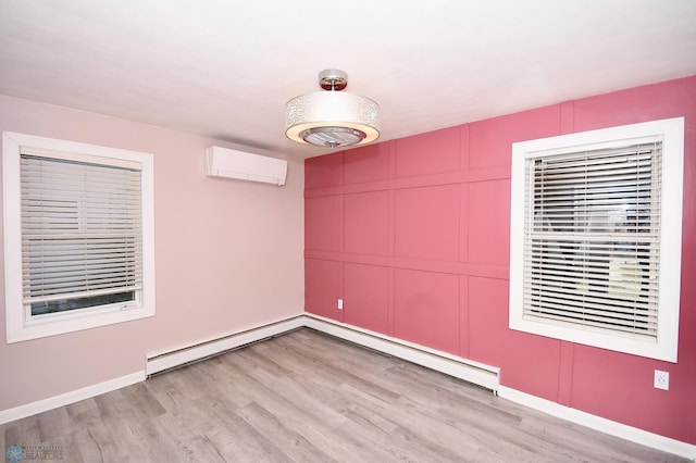 1253 3rd St N, Fargo, ND 58102 - empty room featuring an AC wall unit, light wood-style flooring, and a decorative wall