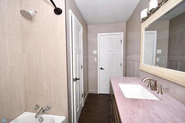 1253 3rd St N, Fargo, ND 58102 - bathroom with vanity, washtub / shower combination, wood finished floors, and a wainscoted wall