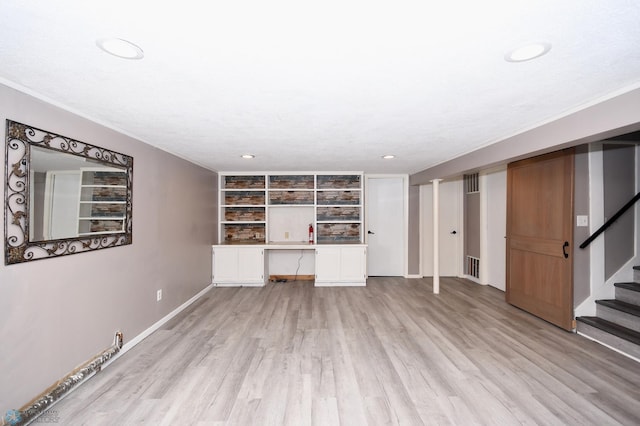 1253 3rd St N, Fargo, ND 58102 - unfurnished living room featuring light wood-style flooring, stairway, built in study area, and recessed lighting
