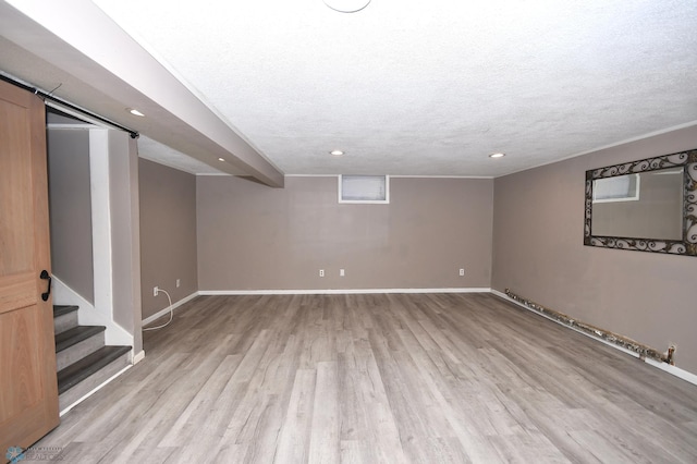 1253 3rd St N, Fargo, ND 58102 - finished below grade area featuring light wood-style flooring, recessed lighting, a textured ceiling, and stairs