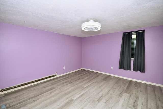 1253 3rd St N, Fargo, ND 58102 - spare room featuring wood finished floors and a textured ceiling