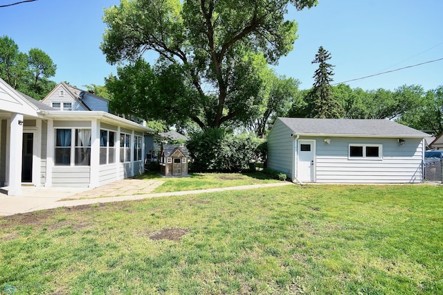 1253 3rd St N, Fargo, ND 58102 - view of green lawn featuring a patio, a storage shed, and a sunroom