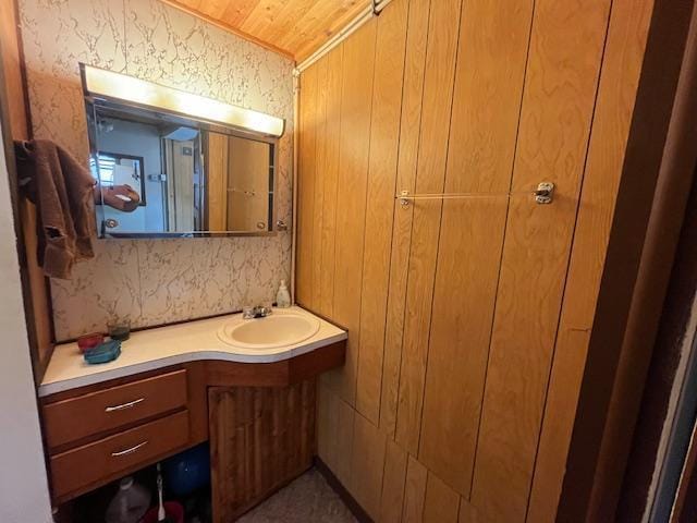 2750 330th St, Sterling Twp, WI 54840 - bathroom with vanity, wooden ceiling, and wallpapered walls