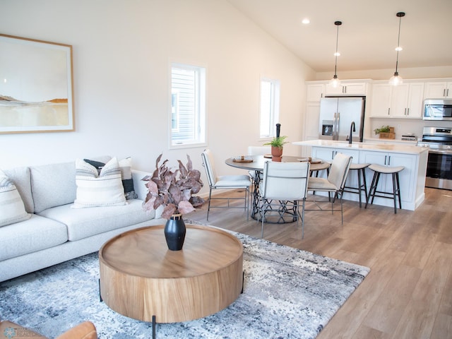 6725 Meadow View Dr S, Fargo, ND 58104 - living room featuring lofted ceiling, light wood-type flooring, and recessed lighting