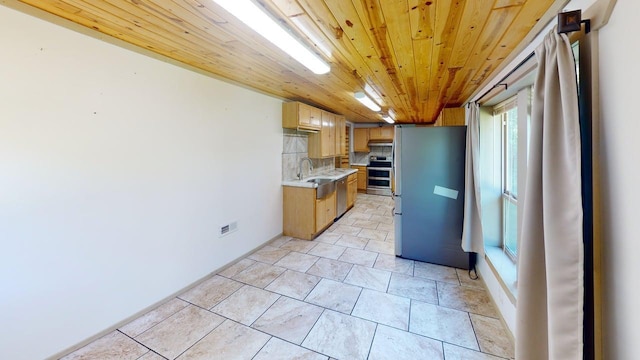 1001 3rd St SW, Crosby, MN 56441 - kitchen featuring appliances with stainless steel finishes, light countertops, wooden ceiling, backsplash, and light tile patterned floors