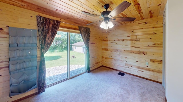 1001 3rd St SW, Crosby, MN 56441 - carpeted empty room with wooden ceiling, wood walls, and a ceiling fan