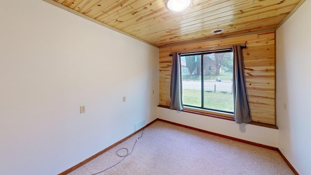 1001 3rd St SW, Crosby, MN 56441 - unfurnished room with wooden walls, wood ceiling, and light carpet