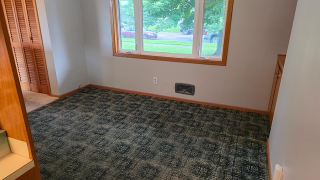 1003 15th St SW, Austin, MN 55912 - carpeted spare room featuring baseboards