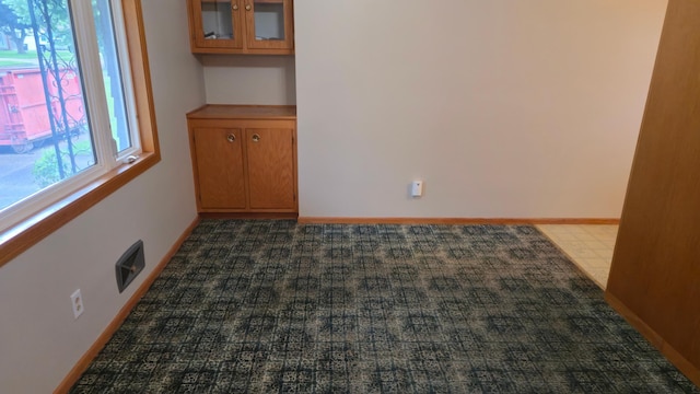 1003 15th St SW, Austin, MN 55912 - empty room with carpet floors and baseboards