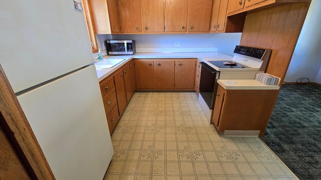 1003 15th St SW, Austin, MN 55912 - kitchen with white appliances, light countertops, and brown cabinetry