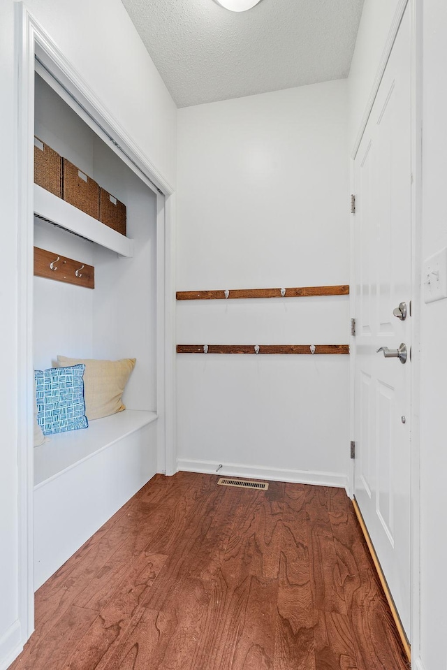 7742 Madelyn Creek Dr, Victoria, MN 55386 - mudroom featuring a textured ceiling and wood finished floors