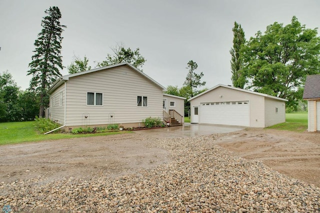604 2nd Ave S, Kindred, ND 58052 - view of side of home with an outdoor structure and a detached garage