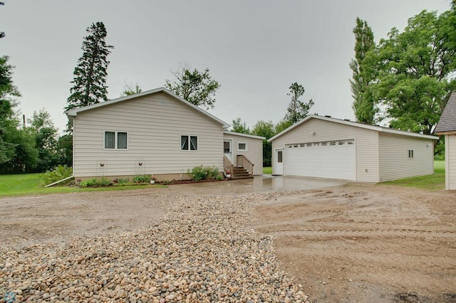 604 2nd Ave S, Kindred, ND 58052 - view of front of property with an outdoor structure, a garage, and entry steps