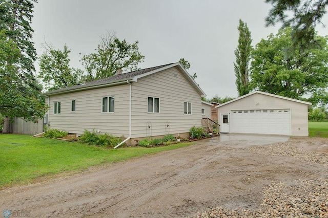 604 2nd Ave S, Kindred, ND 58052 - view of side of home featuring an outdoor structure, a garage, and a lawn