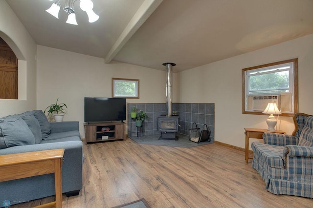 604 2nd Ave S, Kindred, ND 58052 - living area featuring wood finished floors, a wood stove, beamed ceiling, cooling unit, and a chandelier
