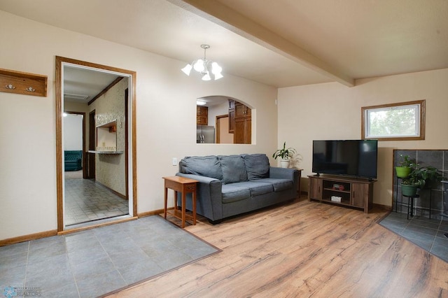 604 2nd Ave S, Kindred, ND 58052 - living area with a chandelier, arched walkways, wood finished floors, and beamed ceiling