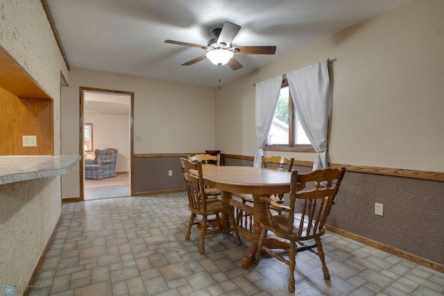 604 2nd Ave S, Kindred, ND 58052 - dining area with ceiling fan, brick patterned flooring, a textured wall, and a textured ceiling