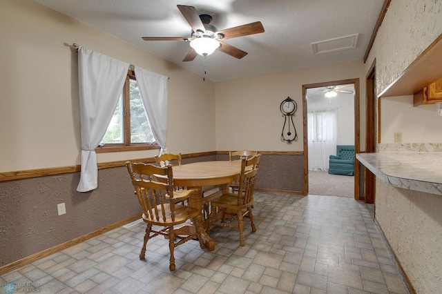 604 2nd Ave S, Kindred, ND 58052 - dining room featuring brick patterned flooring, attic access, and ceiling fan